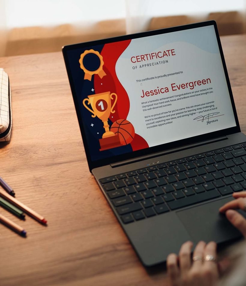 Caucasian teenager girl sitting at desk using laptop, viewing digital certificate of appreciation on screen, hands on keyboard, pencil case and notebook nearby, engaging in academic activity